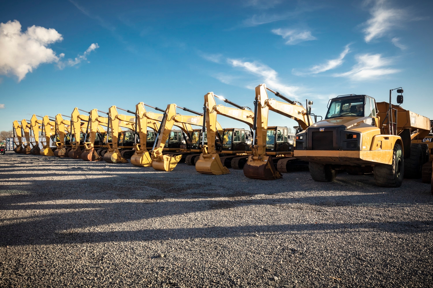 A fleet of cranes and dump trucks.