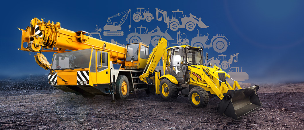 A mobile crane and backhoe loader at the construction site.
