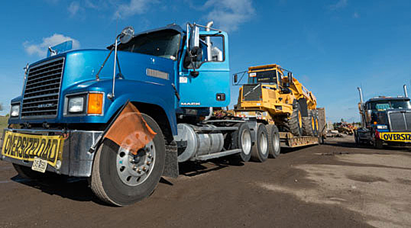 Heavy equipment is being towed.