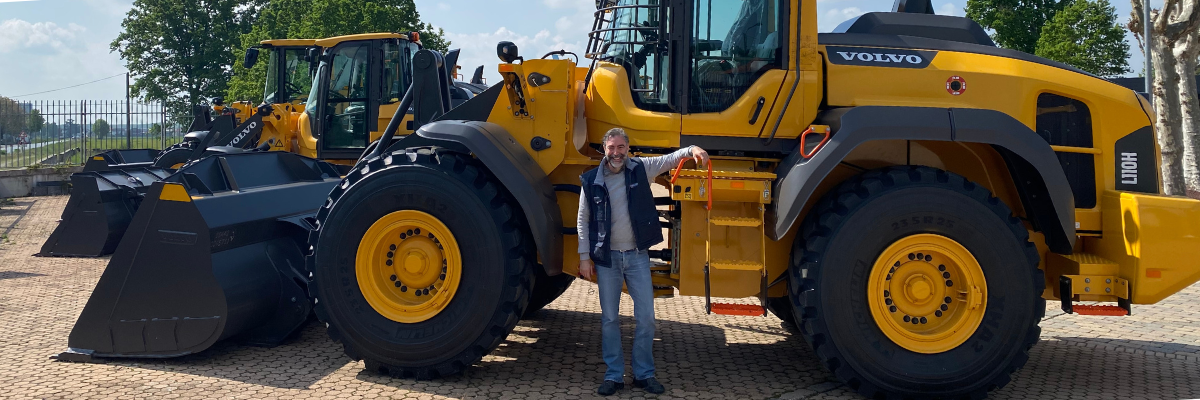 Marco Simionato, stands behind the Volvo heavy equipment.