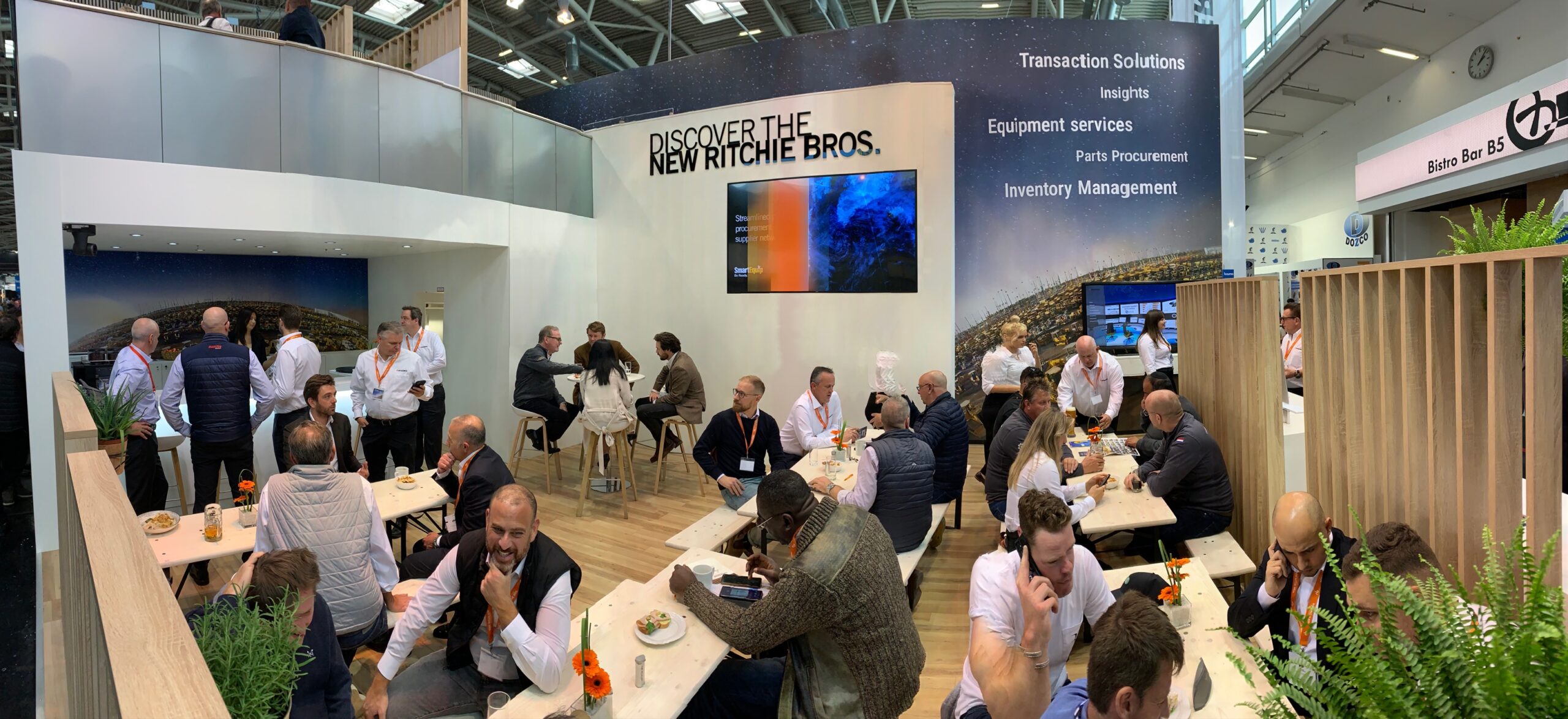 A trade show booth for Ritchie Bros, with a large sign "Discover the new Ritchie Bros. "