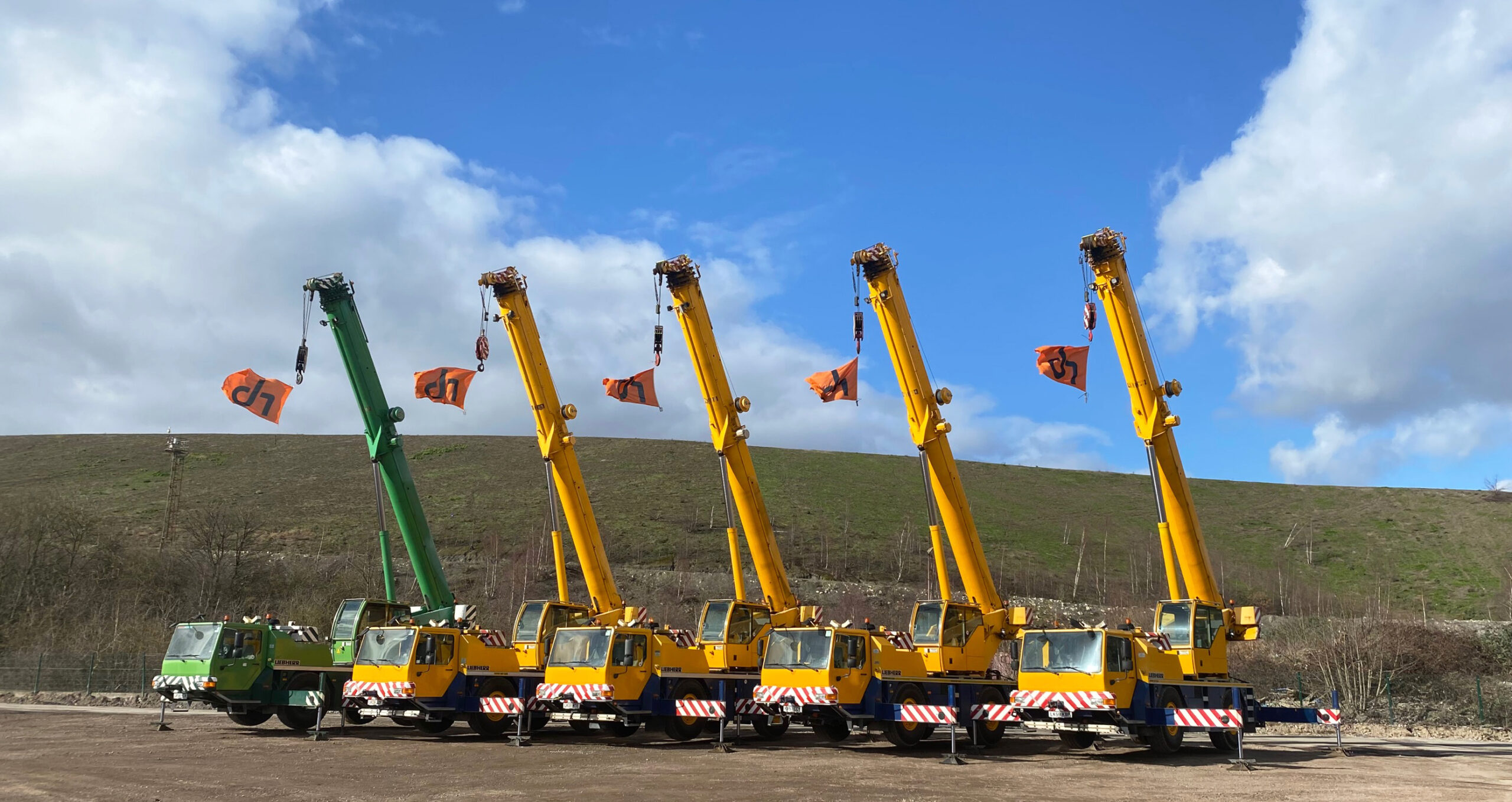 Ainscough all-terrain cranes are parked side by side.