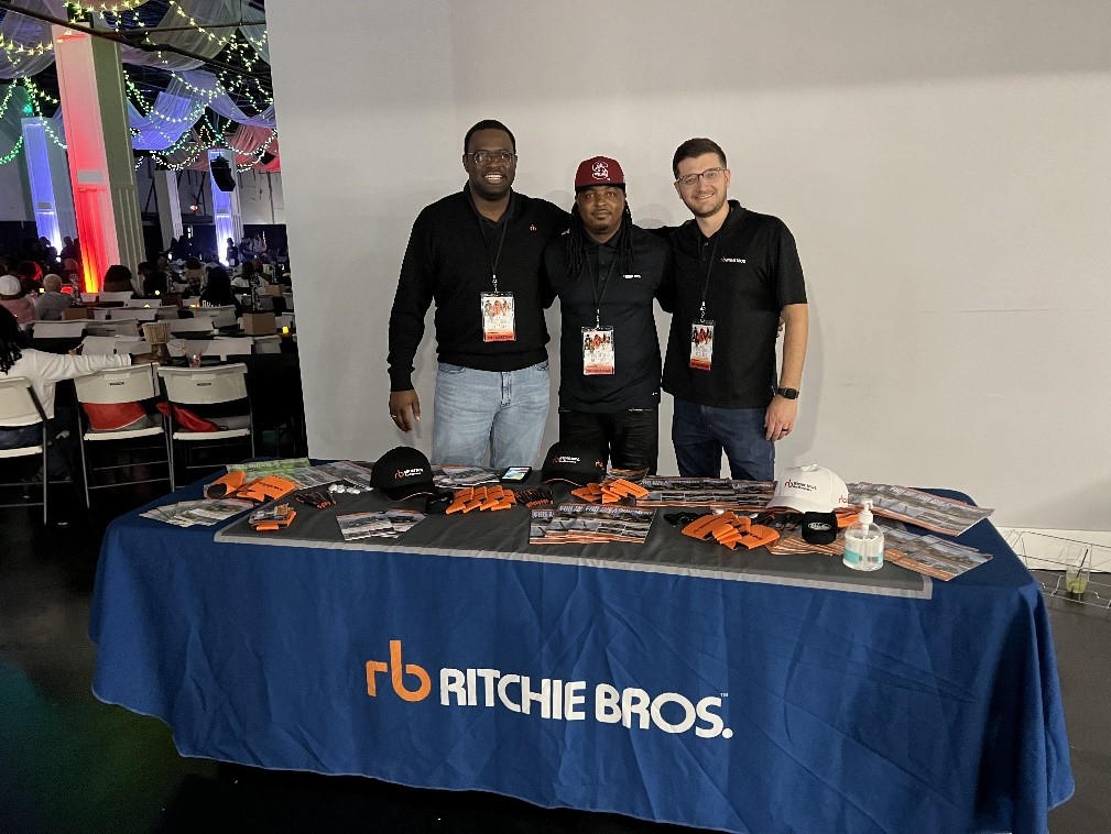 Three RB staff are standing by the table.