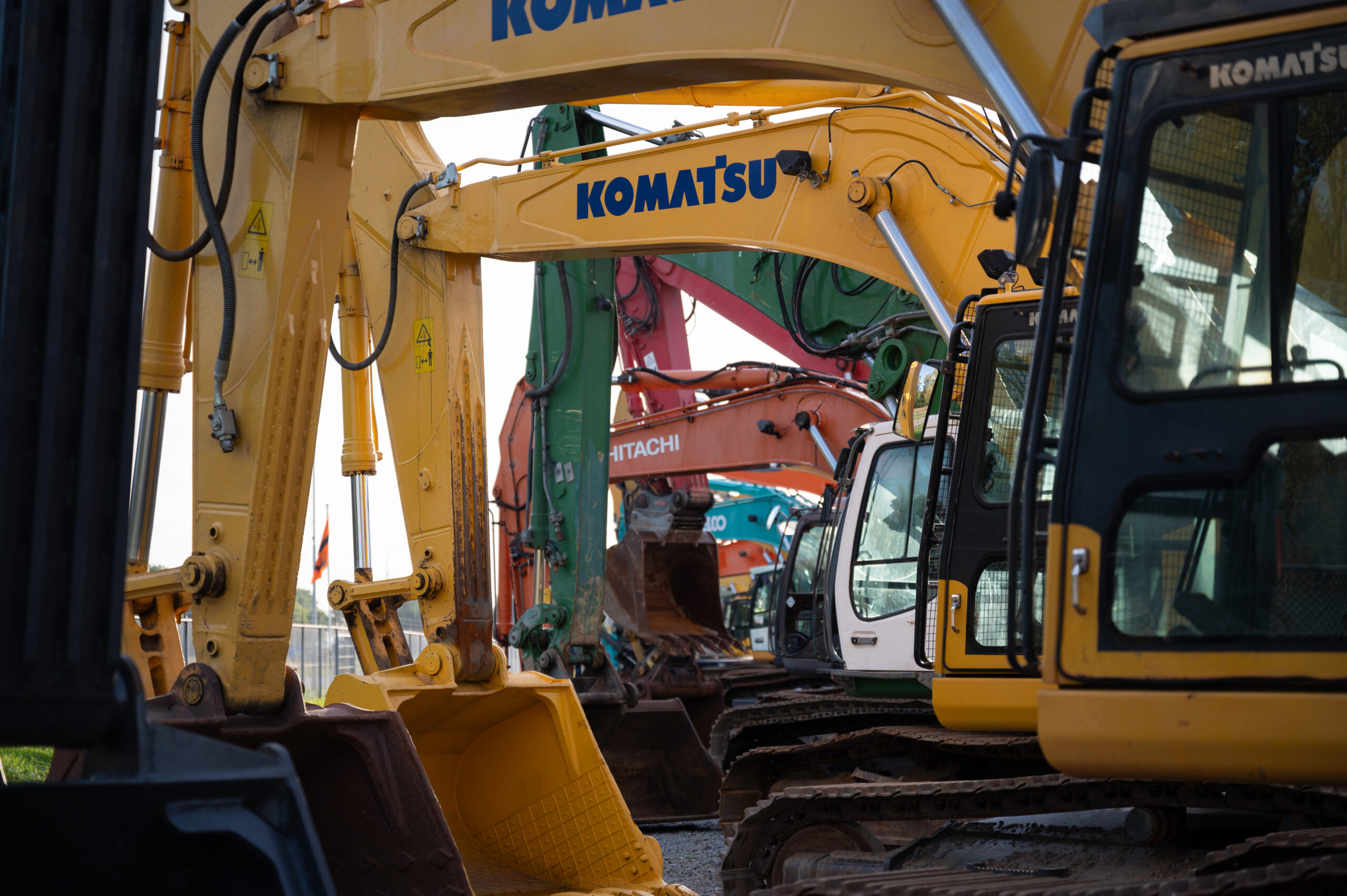 A line of heavy equipment at the auction yard.