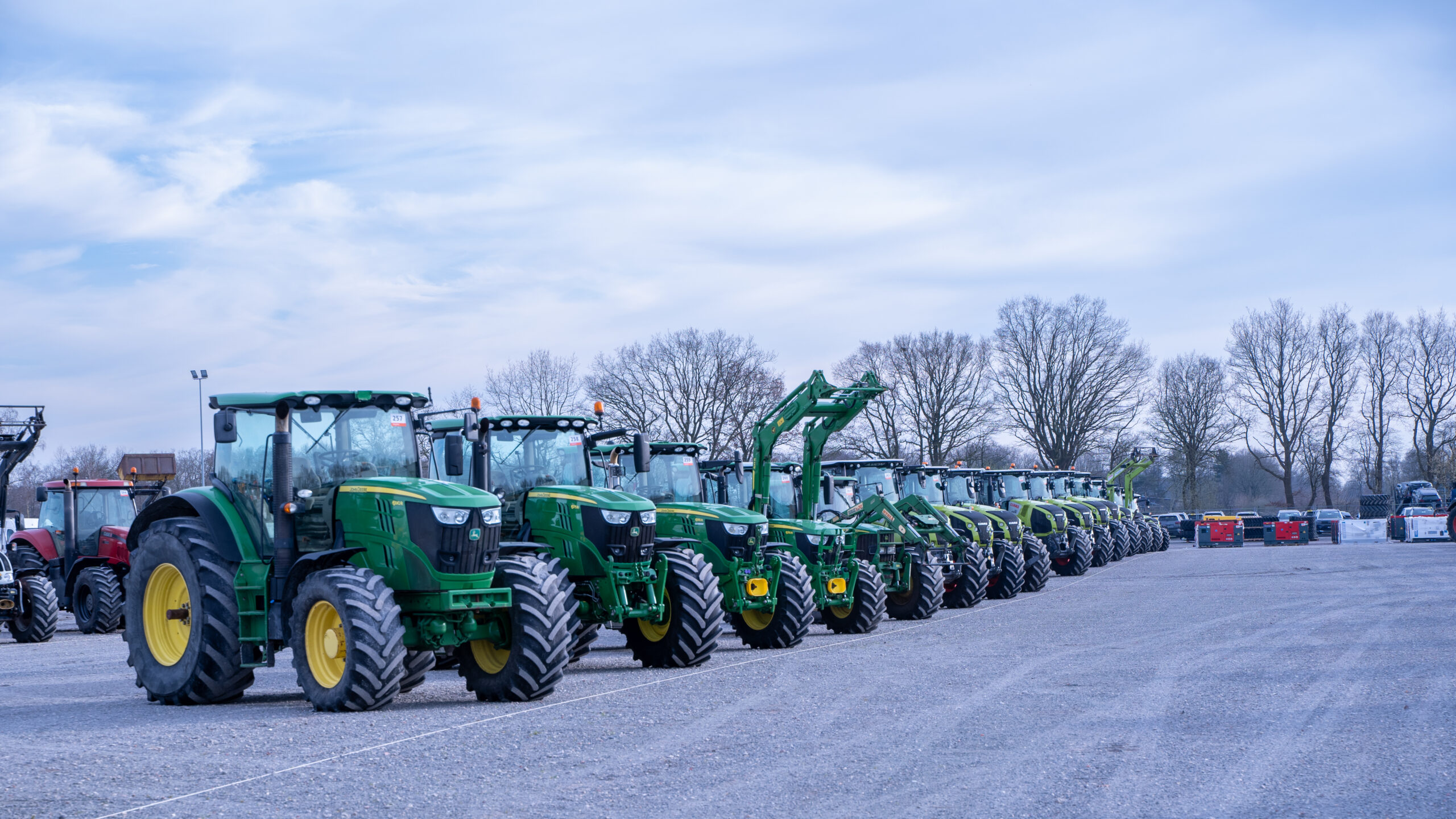 John Deere tractors parked side by side.