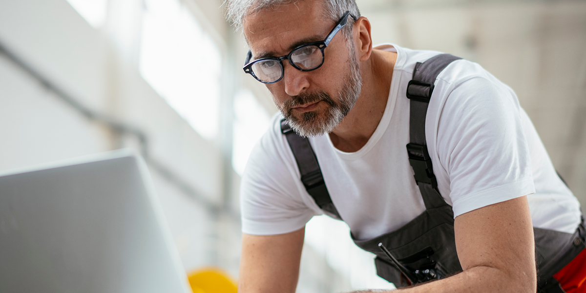 A worker is looking at his computer.