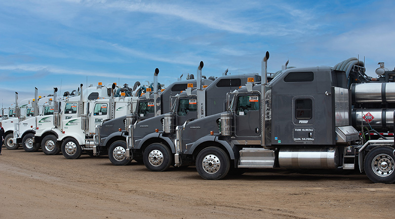 A portrait shows a semi truck parked side by side.
