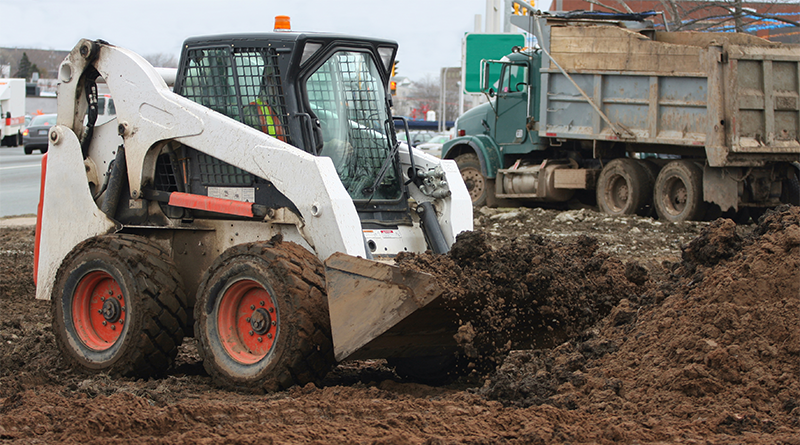 A Skid-steer loader is being used on the construction site