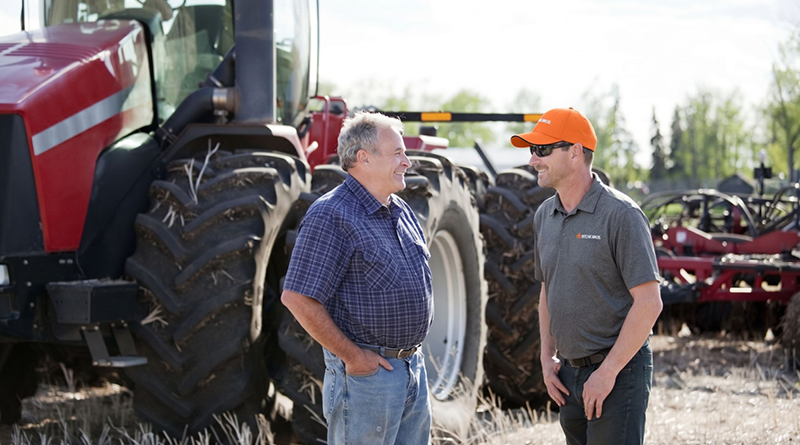 Ritchie Bros. Territory Manager talking with customer.