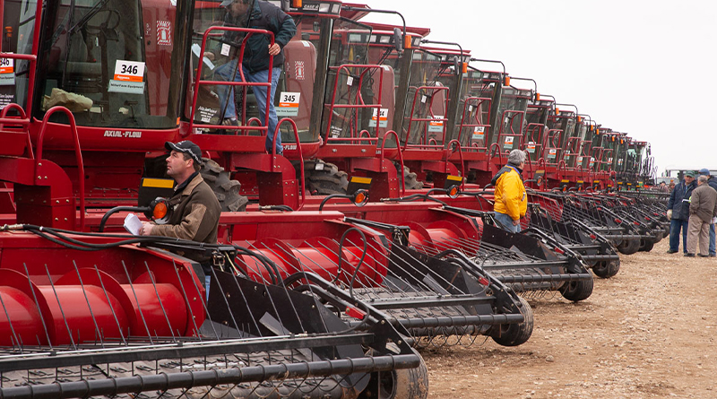 Row of combines at a Ritchie Bros. auction.
